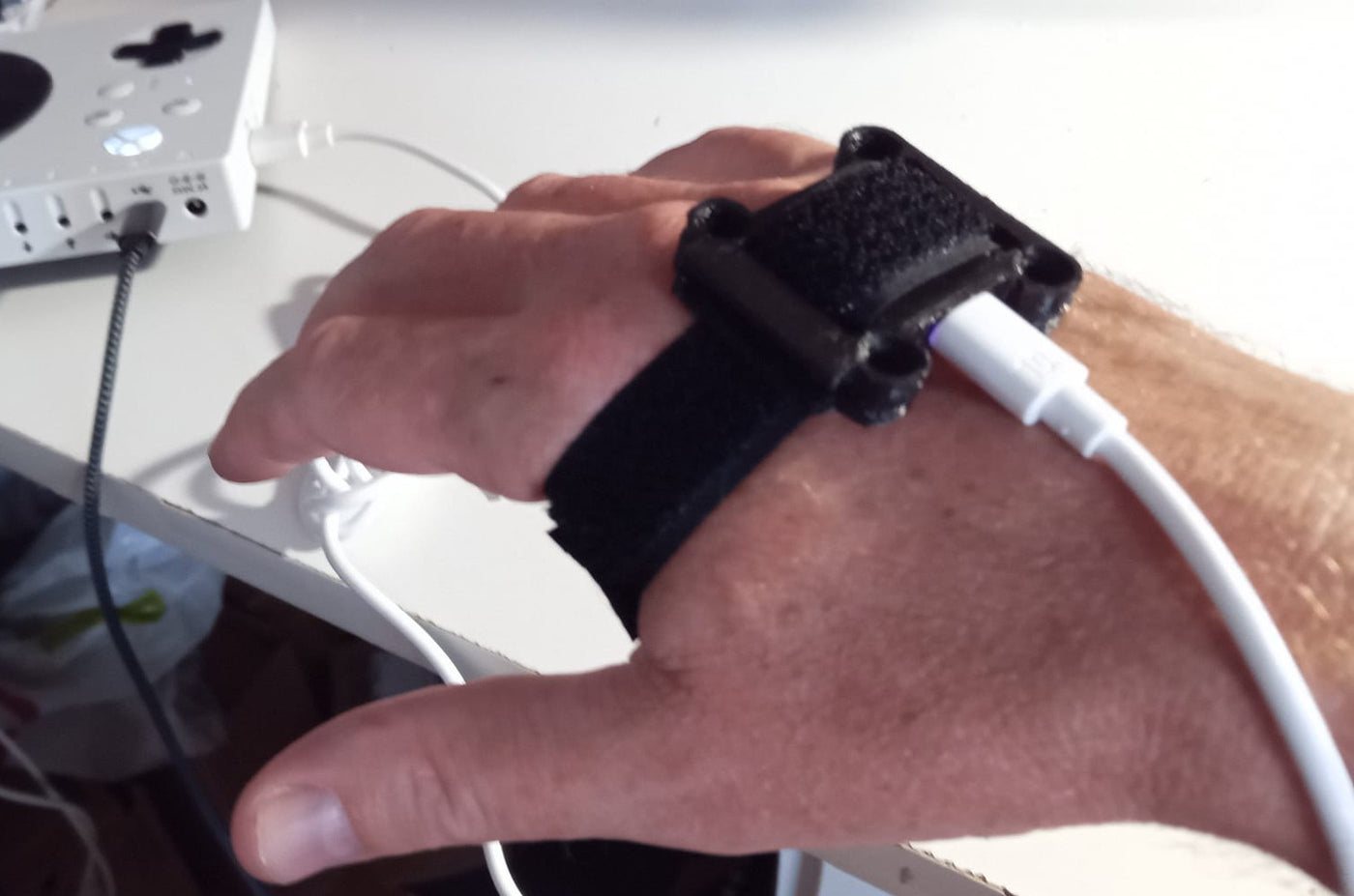 MoveStick strapped to the hand, connected to an adaptive controller.